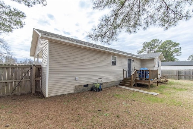 back of property featuring a lawn and a deck