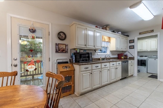 kitchen featuring sink, light tile patterned floors, washer and clothes dryer, tasteful backsplash, and stainless steel dishwasher