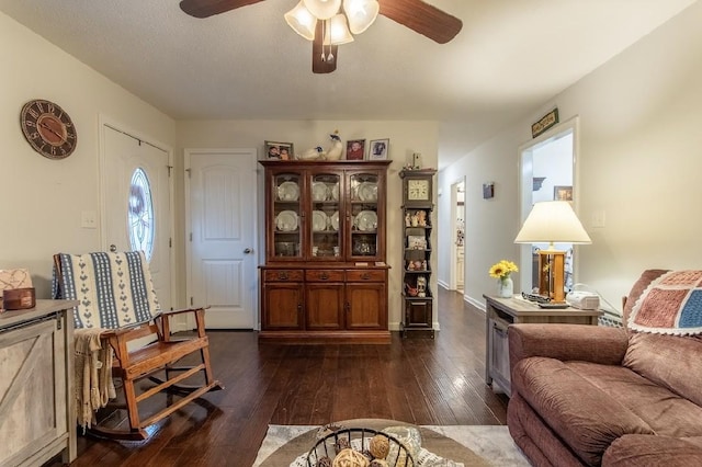 living room with dark hardwood / wood-style floors and ceiling fan