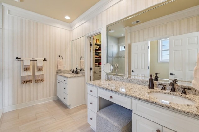 bathroom with ornamental molding and vanity