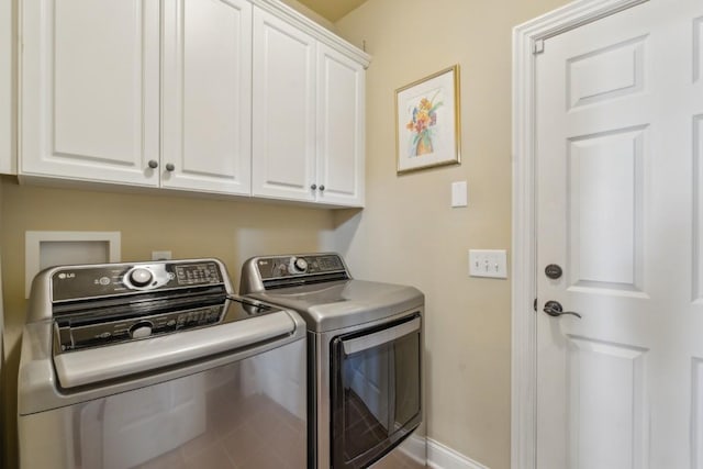 washroom with cabinets and independent washer and dryer