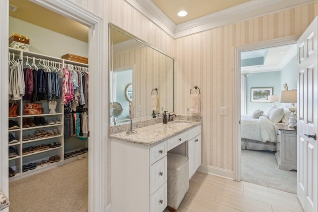 bathroom with crown molding and vanity