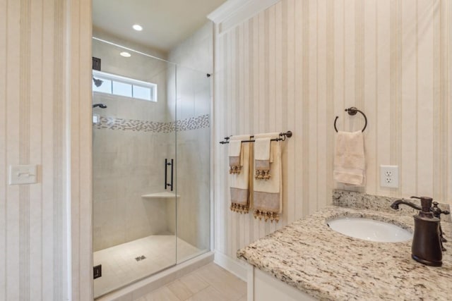 bathroom featuring vanity, tile patterned floors, and a shower with door