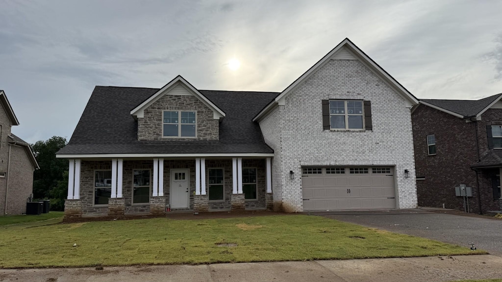 839 Stovers Gln, Murfreesboro, TN 37128 - craftsman-style house featuring driveway, covered porch, a front yard, an attached garage, and brick siding