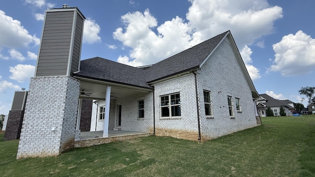 839 Stovers Gln, Murfreesboro, TN 37128 - back of property with a chimney, brick siding, a ceiling fan, and a lawn