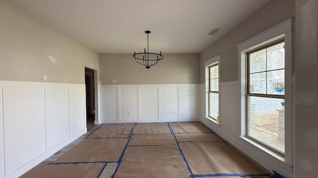 839 Stovers Gln, Murfreesboro, TN 37128 - unfurnished dining area with wainscoting, a chandelier, and a decorative wall
