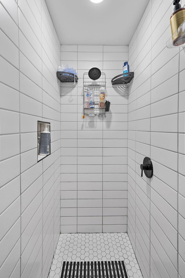 bathroom with a tile shower