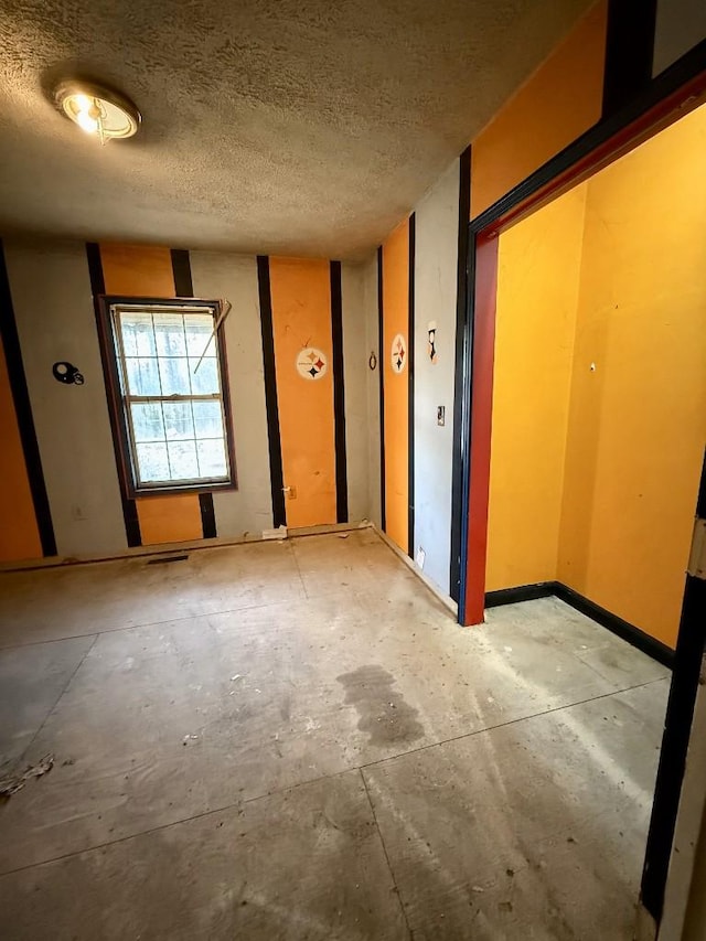 spare room featuring a textured ceiling