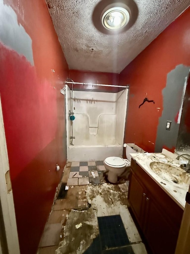 full bathroom with shower / washtub combination, vanity, a textured ceiling, and toilet