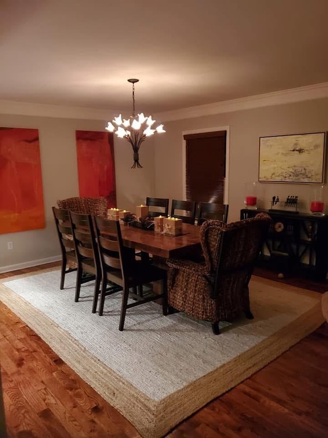 dining room featuring ornamental molding and wood finished floors