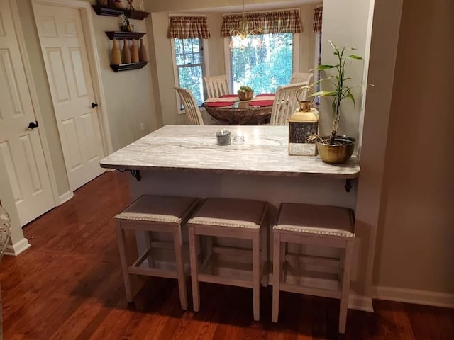 dining space with dark wood-style floors and baseboards