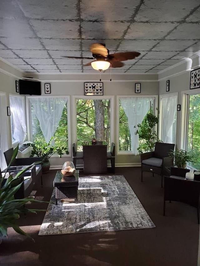 sunroom / solarium featuring ceiling fan