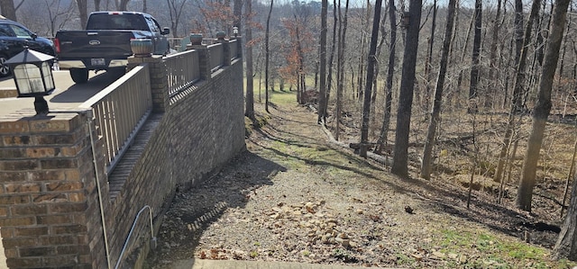 view of yard featuring a forest view