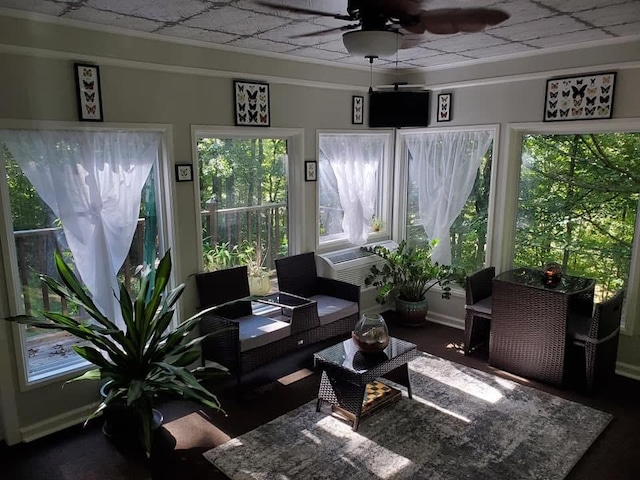 sunroom featuring a ceiling fan and cooling unit