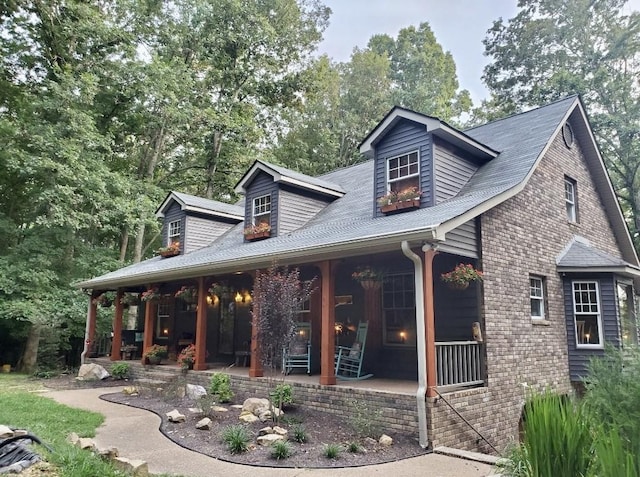 view of front facade with a porch and brick siding