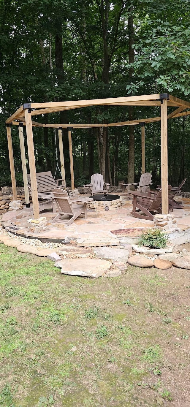 exterior space featuring an outdoor fire pit and a patio