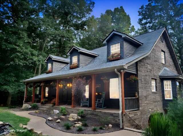 rear view of property with covered porch