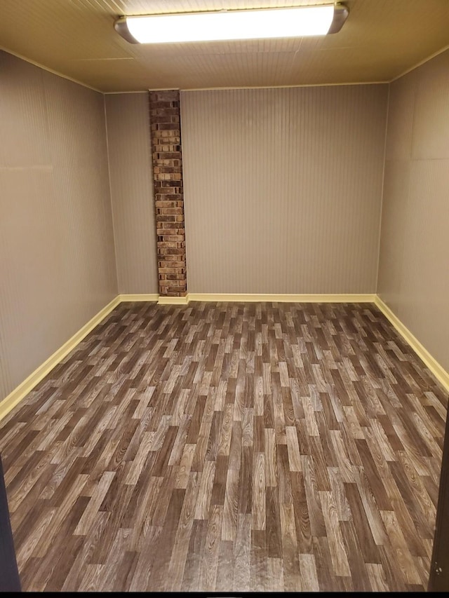 spare room with wood finished floors and baseboards