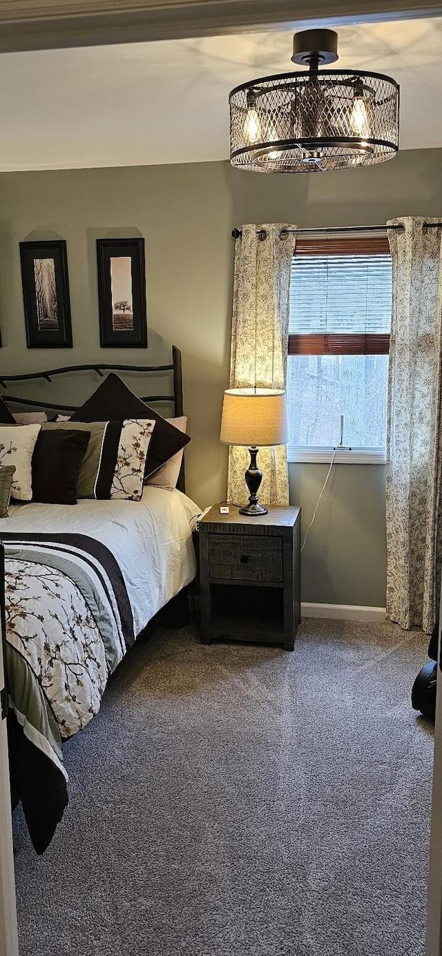 carpeted bedroom featuring baseboards