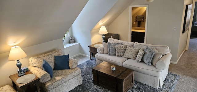 living room featuring carpet, lofted ceiling, and baseboards