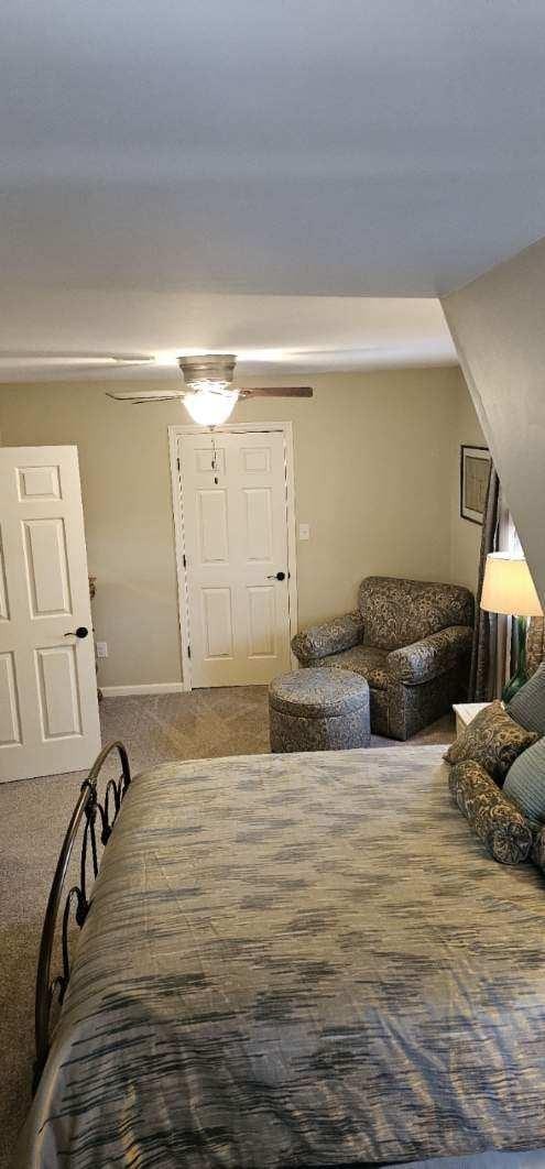 carpeted foyer with baseboards