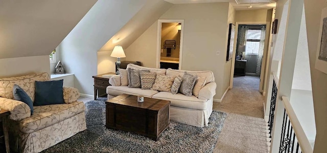 living area featuring carpet floors, attic access, vaulted ceiling, and baseboards