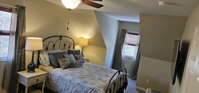 carpeted bedroom featuring ceiling fan and multiple windows