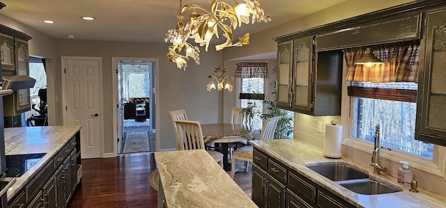 kitchen with tasteful backsplash, dark wood-style flooring, a chandelier, a sink, and recessed lighting