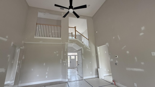 835 Stovers Gln, Murfreesboro, TN 37128 - unfurnished living room featuring a ceiling fan, baseboards, visible vents, tile patterned flooring, and a high ceiling