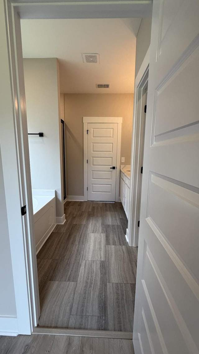 835 Stovers Gln, Murfreesboro, TN 37128 - bathroom featuring vanity, a bath, and wood finished floors