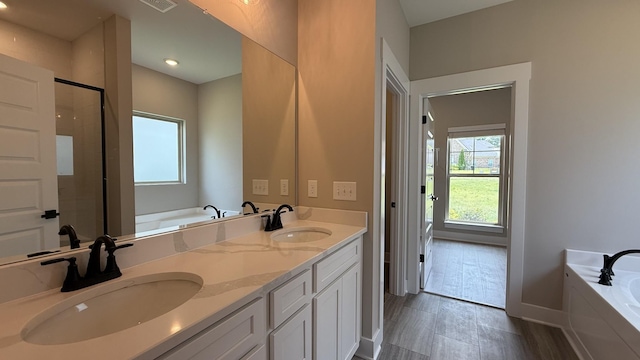 835 Stovers Gln, Murfreesboro, TN 37128 - bathroom featuring a bath, double vanity, a shower stall, and wood finished floors