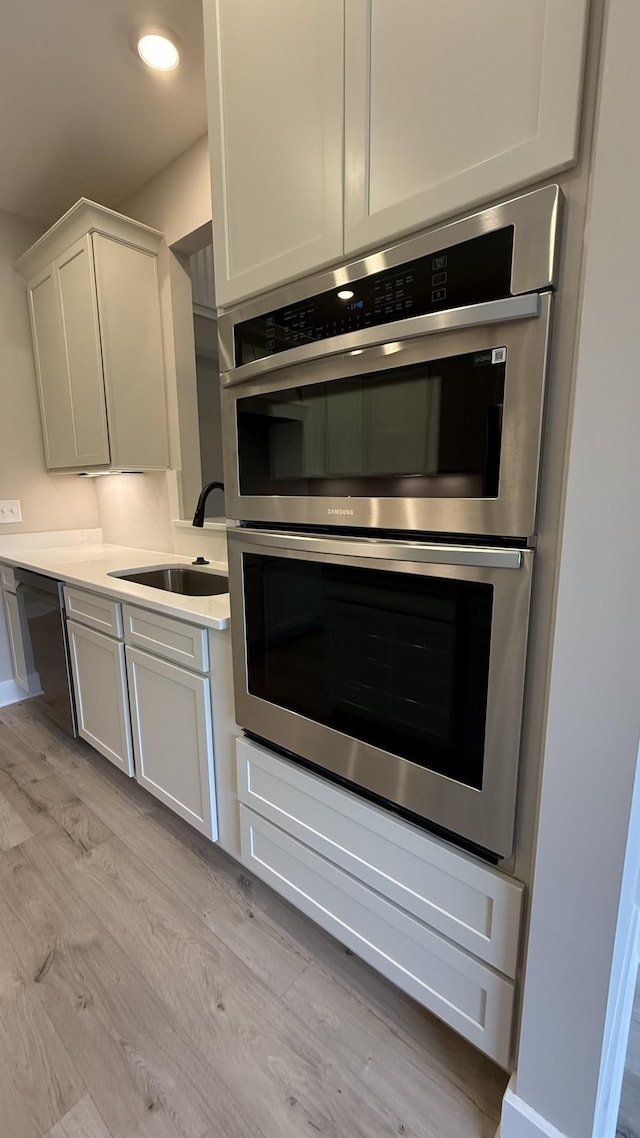 835 Stovers Gln, Murfreesboro, TN 37128 - kitchen with stainless steel appliances, light wood finished floors, light countertops, white cabinetry, and recessed lighting