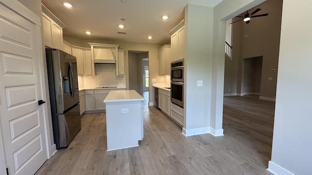 835 Stovers Gln, Murfreesboro, TN 37128 - kitchen with appliances with stainless steel finishes, light wood finished floors, a center island, light countertops, and a ceiling fan