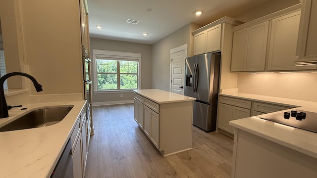 835 Stovers Gln, Murfreesboro, TN 37128 - kitchen with stainless steel appliances, light wood finished floors, a center island, light stone counters, and recessed lighting