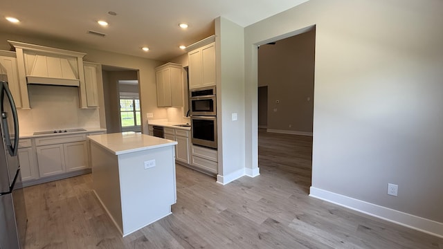 835 Stovers Gln, Murfreesboro, TN 37128 - kitchen with freestanding refrigerator, light countertops, light wood-style flooring, a kitchen island, and recessed lighting