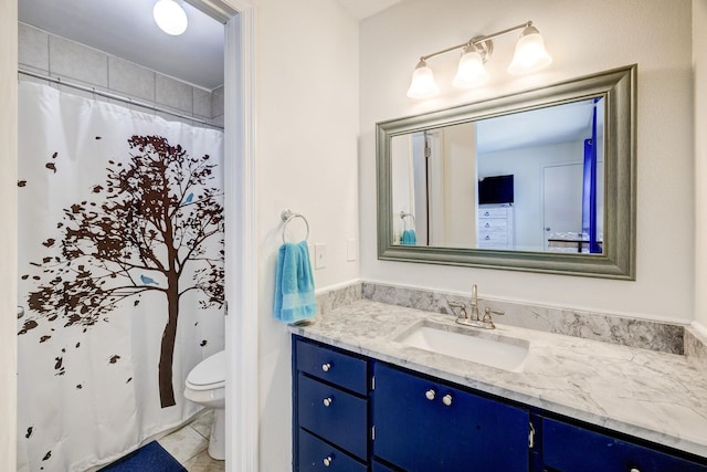 bathroom featuring vanity and toilet