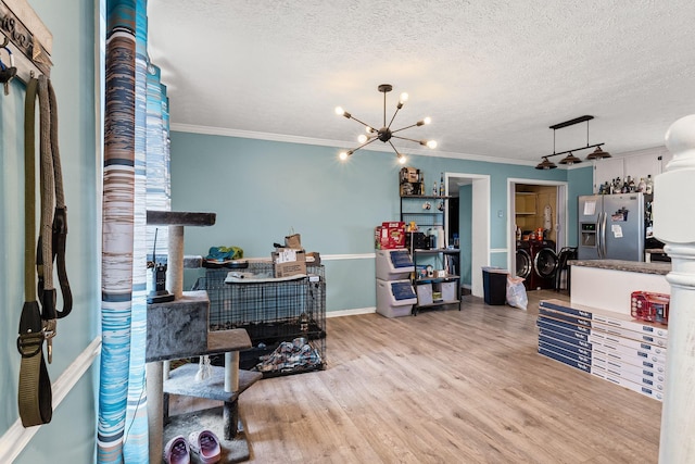 office with a notable chandelier, ornamental molding, a textured ceiling, and light wood-type flooring