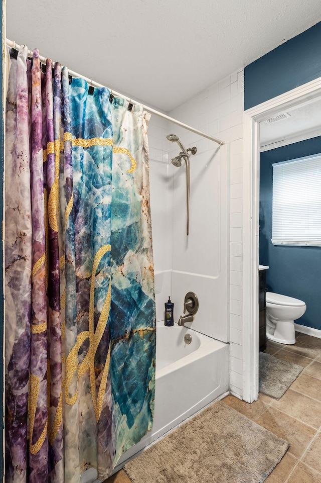 bathroom with shower / tub combo and toilet