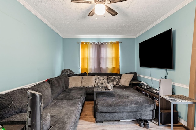 living room with crown molding, light hardwood / wood-style flooring, a textured ceiling, and ceiling fan