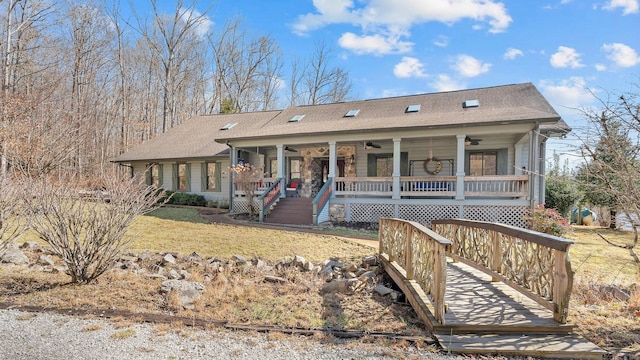 ranch-style house with a front lawn, ceiling fan, and a porch