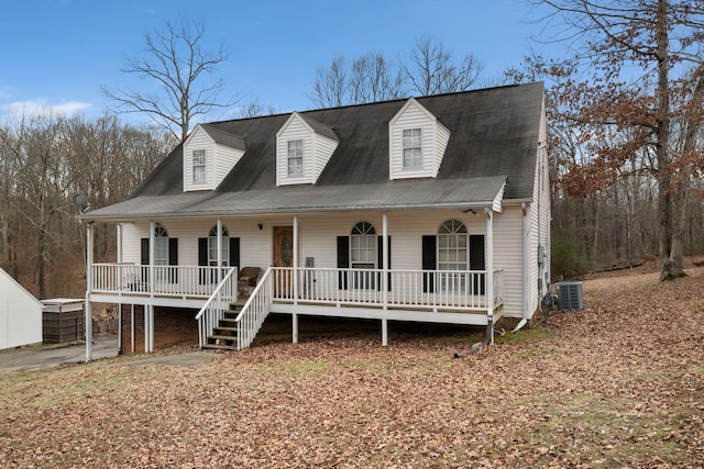 new england style home with a porch and central air condition unit