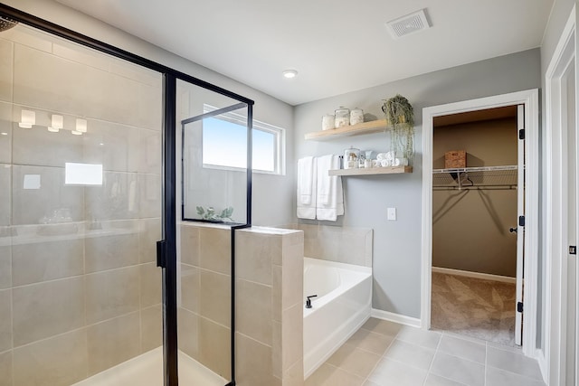 bathroom featuring plus walk in shower and tile patterned flooring