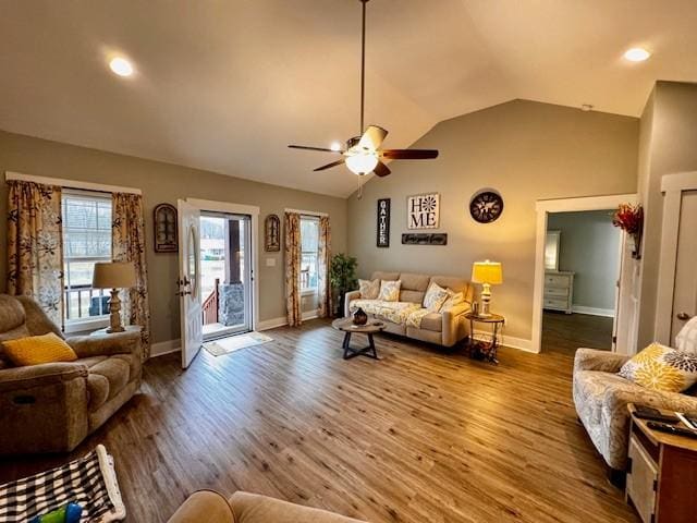 living room featuring vaulted ceiling, ceiling fan, and hardwood / wood-style floors