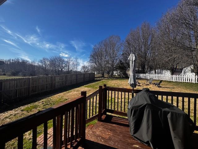 wooden deck with a grill