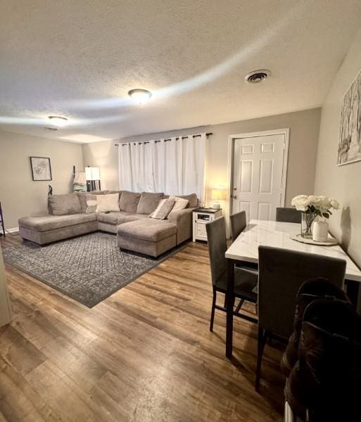 living room with hardwood / wood-style floors and a textured ceiling