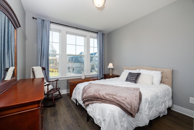 bedroom with dark hardwood / wood-style flooring