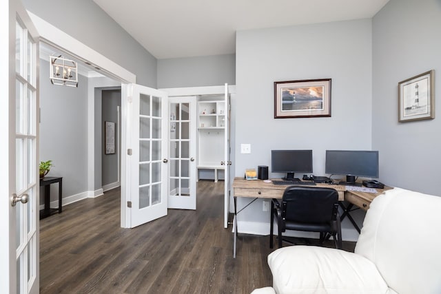 home office with a notable chandelier, dark hardwood / wood-style floors, and french doors