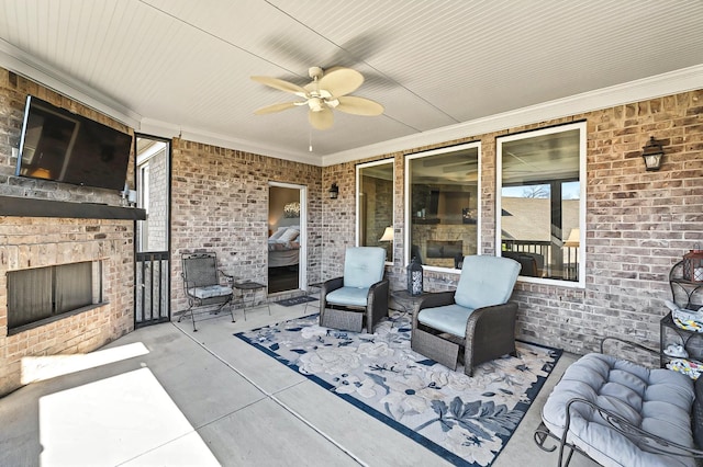 view of patio featuring an outdoor brick fireplace and ceiling fan