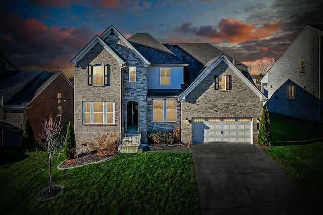 view of front facade featuring a garage and a lawn