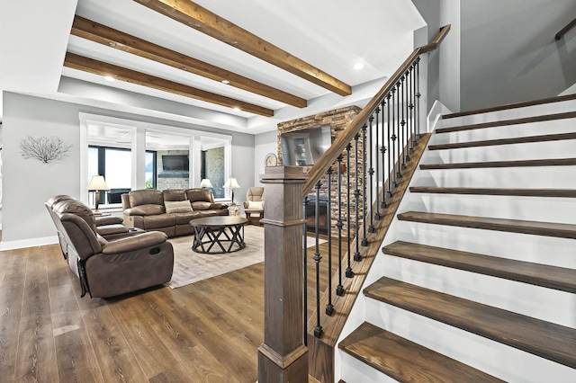 living room with beamed ceiling and wood-type flooring